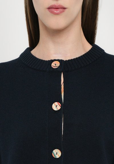 Navy-blauer Strickcardigan mit einem gerippten Kragen, drei bunten Holzknöpfen am Ausschnitt und einer kleinen Vorderöffnung.