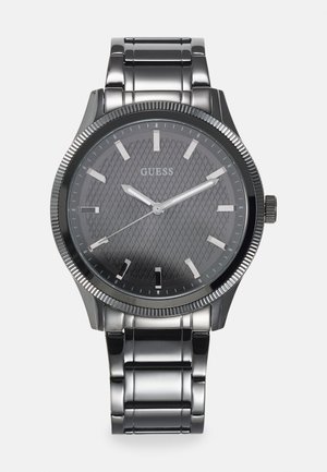 Metal wristwatch with a gray textured dial, silver hour markers, and a polished silver band. Features a stainless steel case and crown.