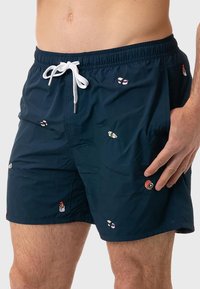 Pantaloni da bagno della marina realizzati in tessuto leggero, con motivi colorati di sushi e vita con coulisse bianca.