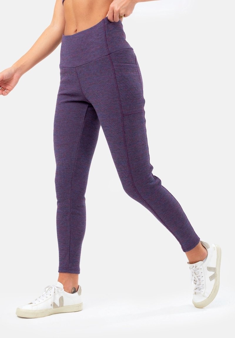 Leggings viola a vita alta con un tessuto a maglia testurizzato, design slim-fit e tasche laterali. Abbinati a sneakers bianche.