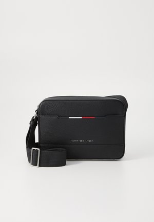 Svart lær crossbody-veske med teksturert finish, med en horisontal stripe i rød, hvit og blå. Justerbar stropp og logodetalj.