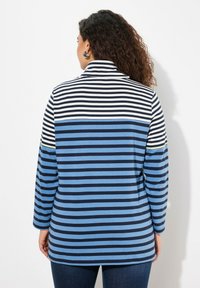 Gestreiftes Langarmshirt mit abwechselnd dunkelblauben, hellblaue und weißen Streifen, einem Mock-Kragen und einer lockeren Passform.