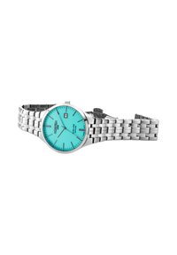 Reloj de acero inoxidable plateado con un dial redondo color turquesa, superficie texturizada y marcadores de hora plateados. Presenta una pulsera de eslabones plateada.