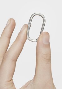 Moschettone ovale in acciaio inossidabile tenuto tra le dita, con finitura lucida e un gancio a molla per una chiusura sicura.