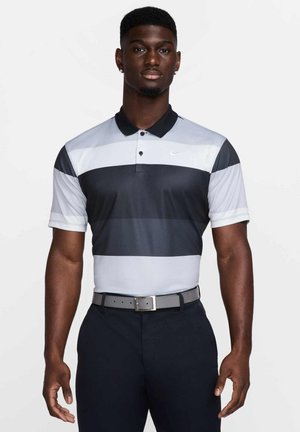 Polo shirt with a striped design in shades of grey and black, short sleeves, and a black collar. Features a Nike logo on the chest.