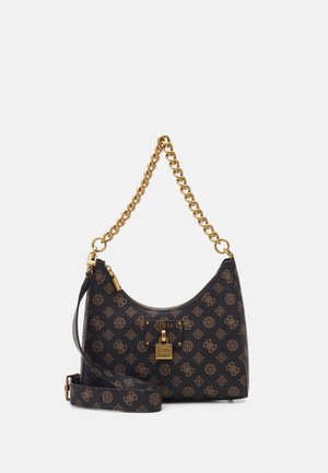 Black and brown patterned Guess handbag with gold chain handle, gold lock detail, and an additional adjustable shoulder strap.