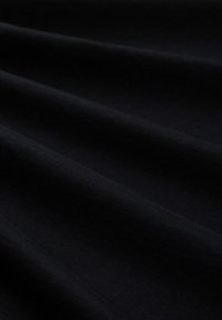 Black fabric with soft folds and a smooth texture, shown in close-up detail.