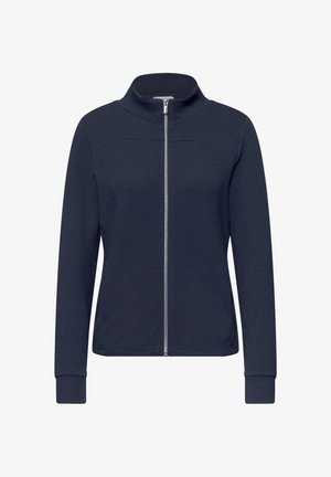 Veste pour femme bleu marine texturée avec fermeture éclair complète à l'avant, manches longues et col montant, présentée sur un fond blanc.