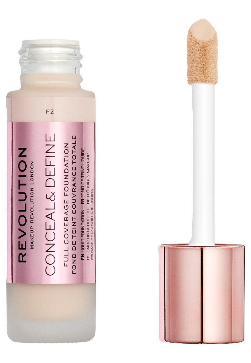 Fond de teint Revolution Conceal & Define dans un flacon en verre transparent avec des accents roses. Il est doté d'un applicateur effilé pour une utilisation facile. Teinte F2.