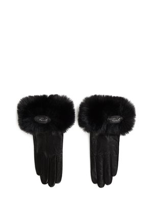 Sorte lærhansker med en fluffy svart faux fur mansjett. Har et ovalt logo-patch ved håndleddet. Glatt tekstur med en strukturert form.