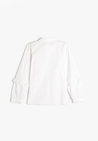 Blusa di cotone bianca con colletto, maniche con volant e chiusura con bottoni ai polsi. Texture liscia con un design classico.