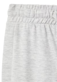 Szare dresy wykonane z teksturowanej tkaniny, z elastycznym paskiem w talii i lekko heathered wyglądem. Brak widocznych kieszeni lub akcentów.