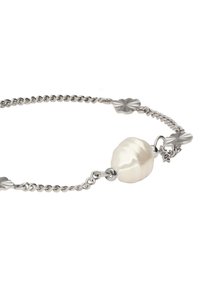 Silver chain bracelet featuring a large irregular-shaped white pearl at the center, with decorative leaf-shaped links throughout.