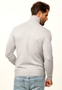 Light gray sweater with a high collar, ribbed cuffs, and hem. Features a close-fitting design and soft knit texture. Back view displayed.