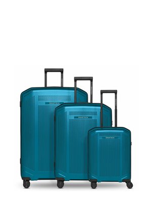 Tre valigie rigide color verde acqua con manici telescopici e quattro ruote rotanti, disposte dalla più grande alla più piccola, etichettate SMARTBOX.