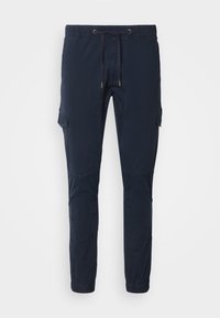 Pantalon jogger cargo bleu marine avec taille élastique, cordon de serrage, poches à rabat sur les côtés et poignets élastiques aux chevilles.