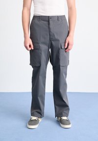 Gray cargo pants with an elastic waistband, two front pockets, and two side pockets, made from a smooth, durable fabric.