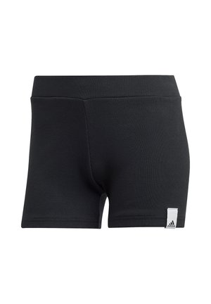 Short de sport noir en tissu côtelé avec une large ceinture et une petite étiquette blanche avec le logo Adidas sur l'ourlet de la jambe gauche.