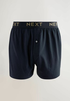 Navyblaue Baumwoll-Boxershorts verfügen über einen elastischen Bund mit "NEXT" in Gold, einen Knopfverschluss vorne und eine lockere Passform.