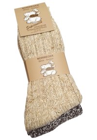 Calze lavorate a maglia in colori beige e marrone scuro, caratterizzate da un design a coste. Include un'etichetta con illustrazioni di pecore e dettagli del prodotto.