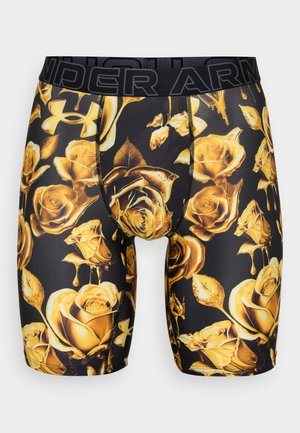 Black boxer shorts featuring a gold rose pattern, made from stretch fabric with an elastic waistband displaying "Under Armour."