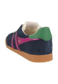 Navy blue suede sneaker with pink accents, green heel, and light tan rubber sole. Features white laces and a logo on the side.