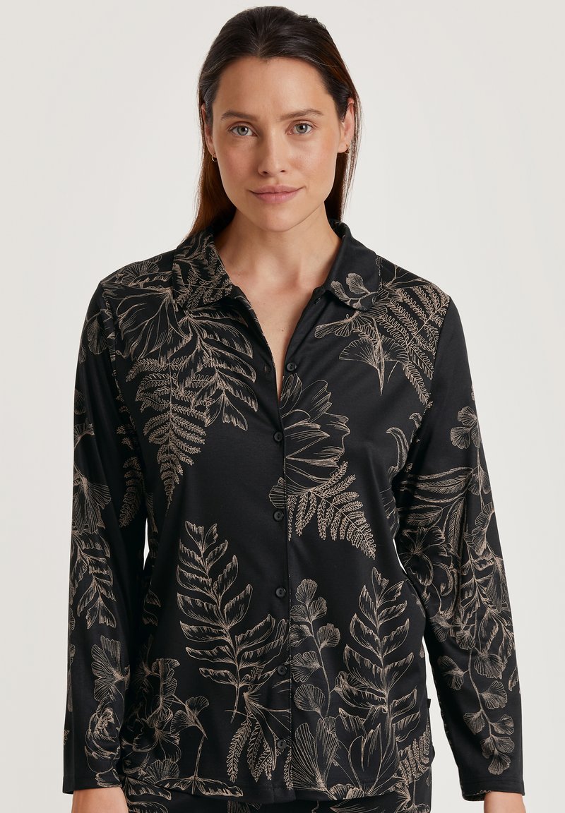 Zwarte lange mouwen shirt met een bloemenpatroon in gouden lijnen, met een kraag en knoopsluiting, gemaakt van zachte stof.