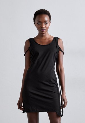 Fekete, ujjatlan ruha puha anyagból, kerek nyakkivágással és kivágott részlettekkel a vállaknál. Egyszerű, testhez simuló fazon.