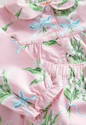 Pink cotton dress with floral pattern, featuring blue bows and green leaves. Ruffled sleeves and a button closure complete the design.