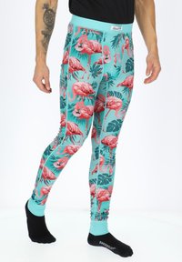 Teal leggings with vibrant pink flamingo and green leaf patterns. Ribbed texture with a contrasting light blue waistband.