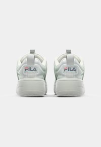 White and mint green athletic sneakers with a smooth finish, padded collar, and a textured white sole featuring a prominent Fila logo.