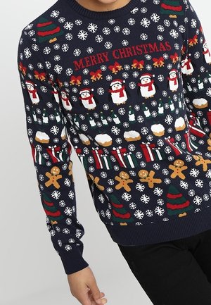 Granatowy sweter z napisem „Wesołych Świąt”, płatkami śniegu, pingwinami, choinkami, skarpetami, piernikowymi ludziki i świątecznymi ikonami.
