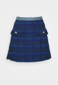 Mini-jupe en tweed texturé bleu et noir avec deux poches à rabat à l'avant, des boutons dorés et une taille grise contrastante.