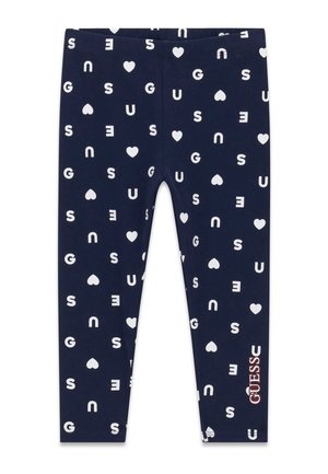 Leggings bleu marine avec des lettres blanches dispersées et des formes de cœur, et un logo rose "GUESS" près du bas de la jambe droite.