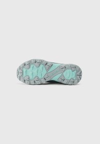 Merrell athletic shoe sole with a textured gray surface and mint green accents, featuring deep treads for traction.