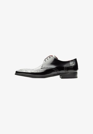 Black leather dress shoe with pointed toe, intricate silver stitching, and perforated accents. Features traditional lace-up design and a low heel.