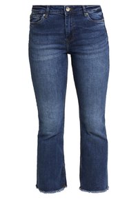 Tummansiniset farkut, joissa on tiukka silhouetti, lyhennetty pituus ja revittävä helma. Klassinen viisi-taskuinen muotoilu metallivarustuksella.