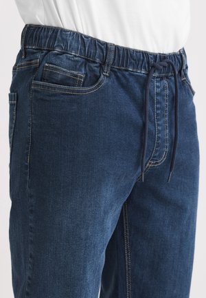 Donkerblauwe denim joggers met een elastische tailleband met trekkoord, voorzakken en contrasterende stiksels langs de naden.