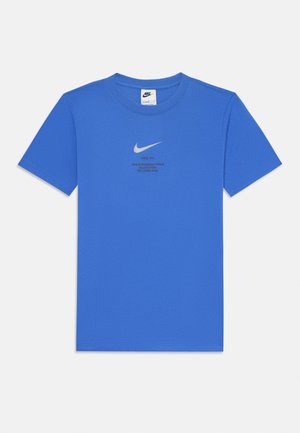 Blue cotton t-shirt with a crew neck, short sleeves, and a reflective silver Nike logo and text on the front. Smooth texture, standard fit.
