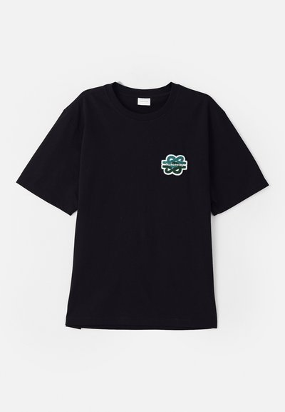 Black cotton t-shirt with short sleeves and round neck. Features a green embroidered logo on the left chest area. Straight hemline.