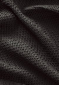 Textured black fabric with a diamond pattern, showcasing a soft, woven surface that appears slightly crumpled and dimensional.
