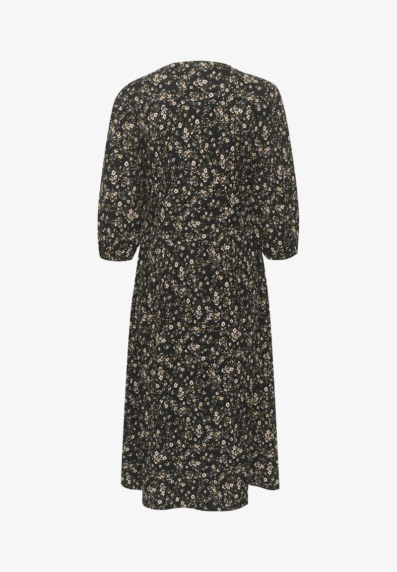 Robe midi noire avec petit imprimé floral blanc et jaune, manches trois-quarts et jupe légèrement évasée, vue de dos.