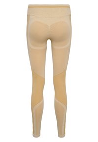 Beige Leggings mit einem strukturierten Muster, ausgestattet mit einem hohen Bund und konturierten Nähten für einen Figur umschmeichelnden Look. Weiches, elastisches Material durchgehend.