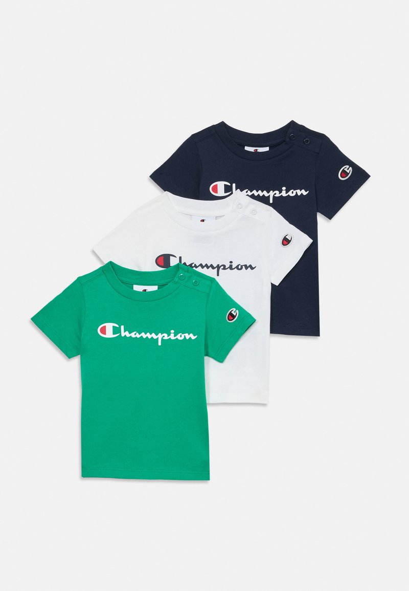 Three short-sleeve t-shirts in green, white, and navy blue. Each features a 'Champion' logo and shoulder snap buttons on the green and white shirts.