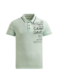 Light green short-sleeve polo shirt with black text and logo reading "Camp David," three brown buttons, and a black collar trim.