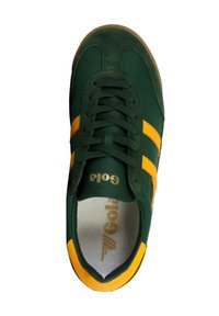 Gröna och gula sneakers med överdel i mocka och tyg, som har tre gula ränder, snörning och en vadderad innersula. Logotyp synlig.