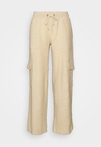 Beige vide ben cargo bukser med et struktureret stof, snor i taljen, to frontlommer og en sidelomme, der har en afslappet pasform.