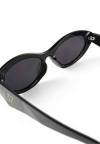 Black sunglasses with a sleek, curved design, dark lenses, and a glossy finish. Notable gold detailing on the temple reads "L37."