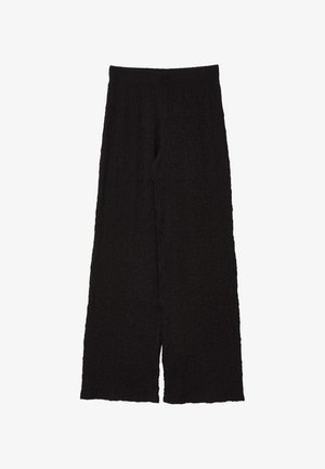 Schwarze weit geschnittene Hosen aus strukturiertem Material, mit einem hohen elastischen Bund und einer entspannten Passform, die knöchellang geschnitten sind.