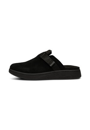 Le clogs neri in suede presentano una forma curva, una cintura texturizzata e una suola leggera in gomma nera con un marchio naturale e morbido.
